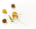 Propolis and honey in glass jars on a white background with copy space