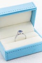 Proposal diamond ring with Tanzanite in jewelry box Royalty Free Stock Photo