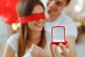 Proposal ring in red box.Love, couple, proposal and people concept - happy man giving diamond engagement ring in little red box to Royalty Free Stock Photo