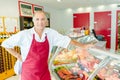 Proprietor Deli leaning on chilled counter