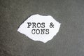 PROS and CONS sign on the torn paper on the gray background Royalty Free Stock Photo