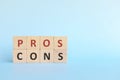 Pros cons typography on wooden blocks. Pros and cons list concept.