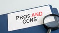 pros and cons word on paper and magnifying lens Royalty Free Stock Photo