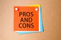 Pros and cons written on red paper and pinned on corkboard Royalty Free Stock Photo