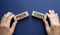 Pros vs Cons symbol. Concept word Pros vs Cons on wooden blocks. Businessman hand. Beautiful deep blue background. Business and Royalty Free Stock Photo