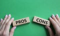 Pros vs Cons symbol. Concept word Pros vs Cons on wooden blocks. Businessman hand. Beautiful green background. Business and Pros Royalty Free Stock Photo