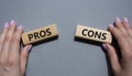 Pros vs Cons symbol. Concept word Pros vs Cons on wooden blocks. Businessman hand. Beautiful grey background. Business and Pros vs Royalty Free Stock Photo