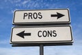 White two street signs with arrow on metal pole with word pros and cons Royalty Free Stock Photo