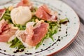 Prosciutto and arugula salad with burrata. Royalty Free Stock Photo