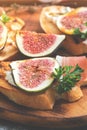 Prosciutto with figs close-up, selective focus. Appetizing sandwich with figs, ham and cheese. Royalty Free Stock Photo
