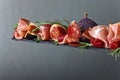 Prosciutto with figs and rosemary. Royalty Free Stock Photo