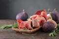 Prosciutto with figs and rosemary. Royalty Free Stock Photo