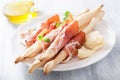 Prosciutto ham and grissini bread sticks. italian antipasto