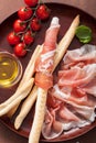 Prosciutto ham and grissini bread sticks. italian antipasto