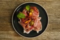 Prosciutto ham plate with olives on wooden table Royalty Free Stock Photo