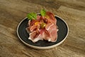 Prosciutto ham plate with olives on wooden table Royalty Free Stock Photo