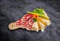Prosciutto - parma smoked ham with vegetables on wooden board an