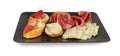 Prosciutto Tapas and Mold Cheese on Black Plate, Spanish Jamon Slices, Parma Ham, Sliced Serrano, Iberico Royalty Free Stock Photo