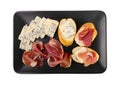 Prosciutto Tapas and Mold Cheese on Black Plate, Spanish Jamon Slices, Parma Ham, Sliced Serrano, Iberico Royalty Free Stock Photo
