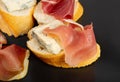 Prosciutto Tapas and Mold Cheese on Black Plate, Spanish Jamon Slices, Parma Ham, Sliced Serrano, Iberico Royalty Free Stock Photo