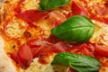 Proscuitto pizza background with meat and mozzarella closeup top view Royalty Free Stock Photo