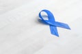 Prostate cancer awareness concept. Blue ribbon on a wooden table Royalty Free Stock Photo