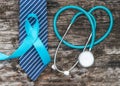 Prostate cancer awareness concept with light blue ribbon on necktie and old aged wood for men`s health care campaign in November Royalty Free Stock Photo