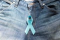 Prostate Cancer Awareness, light Blue Ribbon on jeans background