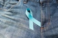 Prostate Cancer Awareness, light Blue Ribbon on jeans background