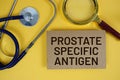 Prostate Specific Antigen (PSA) text on paper card with Stethoscope flat lay on yellow background Royalty Free Stock Photo
