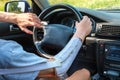 Prosthetic amputated hand of Caucasian man on the steering wheel who drives car