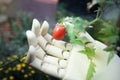 prosthetic hand holding a cherry tomato