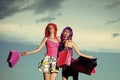 Prostitutes. Girls with artificial hair with colorful shopping bag. Royalty Free Stock Photo