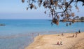 Tourist people enjoying the sandy beach relaxing, sunbathing and swimming in winter. Protaras fig tree bay Cyprus