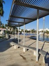 Protaras. Famagusta area. Cyprus. Promenade with a bench and a sunshade, going along the Mediterranean coast to the beach