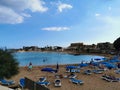 Protaras. Famagusta area. Cyprus. Sandy Kalamies beach with sun loungers and parasols in the bay of the Mediterranean Sea in the