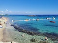 Protaras. Famagusta area. Cyprus. Fig Tree Bay Beach, small island opposite, people sunbathing and swimming on a sunny autumn day