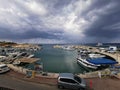 Protaras. Famagusta area. Cyprus. Pier, port with small ships, yachts and boats in the bay of the Mediterranean Sea against the