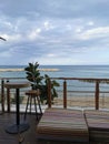 Protaras. Famagusta region. Cyprus. Cafe next to the beach. Tables and bar stools made of sawn wood and low striped mattresses Royalty Free Stock Photo