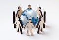 Protect Earth concept. Wooden people figures standing in circle around globe, white background. Collage Royalty Free Stock Photo