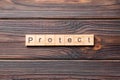 PROTECT word written on wood block. PROTECT text on cement table for your desing, concept