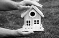 Protect your house concept. Hand holding house representing home ownership and the real estate. Royalty Free Stock Photo