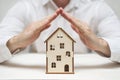 Protect your house. Concept of home insurance with hands over a house. Home insurance concept Royalty Free Stock Photo