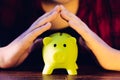 Protect your savings - with hands covering the piggy bank Royalty Free Stock Photo