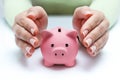 Protect your savings - with hands and piggy bank Royalty Free Stock Photo