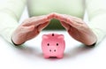 Protect your savings - with hands and piggy bank Royalty Free Stock Photo