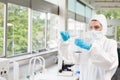 Protected female scientist pouring liquid Royalty Free Stock Photo