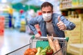 Protected man with hand with ok gesture buying in supermarket Royalty Free Stock Photo