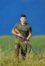 Protecting borders of motherland. Stop illegal immigrants. Man with weapon military clothes in field nature background