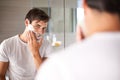 Protecting his face with the correct shaving foam. a young man looking in a mirror to apply shaving foam. Royalty Free Stock Photo